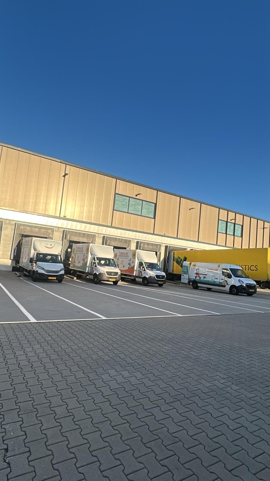 Vrolijk Verhuizen vans lined up at the storage warehouse