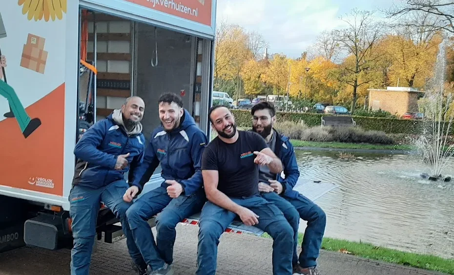4 vrolijke verhuizers in een verhuisbus